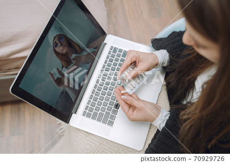 Sick woman with headache sitting at home 70929726