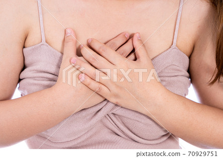 Woman touching her heart or chest isolated white background. 70929751