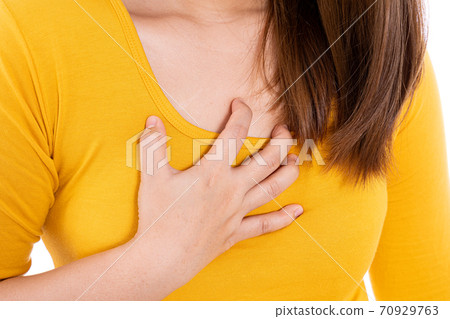 Woman touching her heart or chest isolated white background. Woman touching her heart or chest isolated white background. 70929763