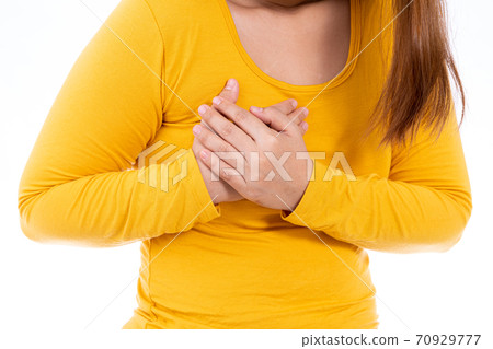 Woman touching her heart or chest isolated white background. Woman touching her heart or chest isolated white background. 70929777