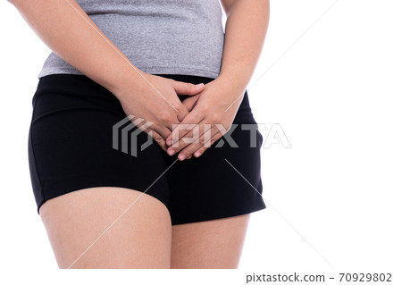 Woman hands holding her crotch suffering from painful stomachache isolated white background. 70929802