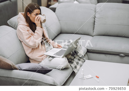 Sick woman with headache sitting at home Sick woman with headache sitting at home 70929850