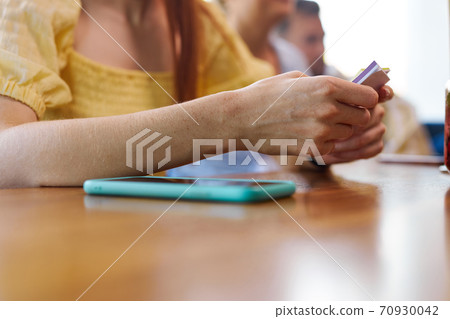 close-up woman hands holding stickers going to play in a cafe close-up woman hands holding stickers going to play in a cafe 70930042