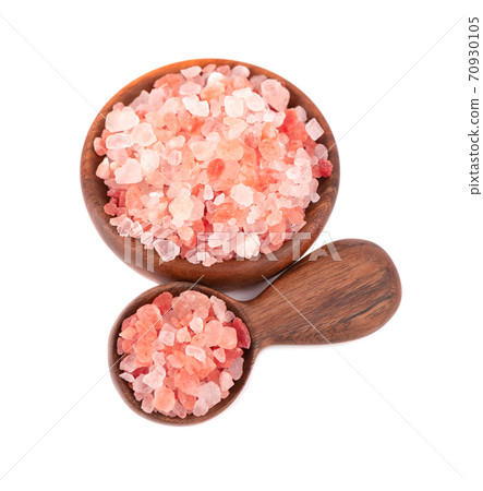 Himalayan pink salt in wooden bowl and spoon, isolated on white background. Himalayan pink salt in crystals. Himalayan pink salt in wooden bowl and spoon, isolated on white background. Himalayan pink salt in crystals. 70930105