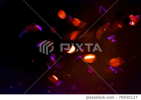 Abstract background, overlay of sparkling confetti in motion on black background 70930127