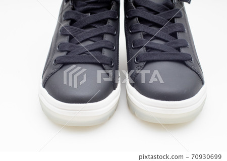 Pair of new black sneakers with white sole on white background Pair of new black sneakers with white sole on white background 70930699