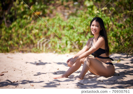 Beautiful asian woman enjoying on a tropical beach 70930761