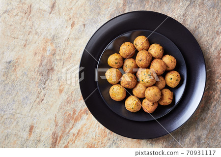 Mediterranean deep-fried falafels on a black plate Mediterranean deep-fried falafels on a black plate 70931117