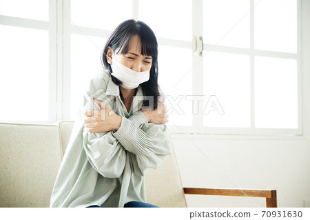 Unwell woman wearing a mask Unwell woman wearing a mask 70931630