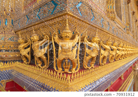 Garuda statue at Golden pagoda at Temple of the Emerald Buddha in Bangkok, Thailand. Wat Phra Kaew and Grand palace in old town, urban city. Buddhist temple, Thai architecture. 70931912