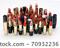 cosmetic lipstick, open tubes on a white background. 70932236