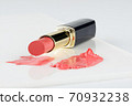 cosmetic lipstick, an opened tube with a smear of lipstick on a white background. 70932238