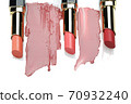 cosmetic lipstick, opened tubes with lipstick smears on a white background. 70932240