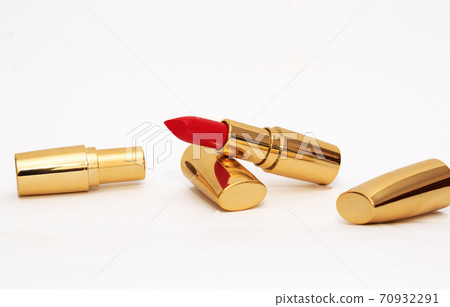 Red lipstick in gold tube on white background. Copy space, close-up  70932291
