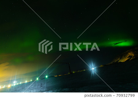 Northern lights in the night sky of iceland. Soft focus. Magical green glow. Northern lights in the night sky of iceland. Soft focus. Magical green glow. 70932799