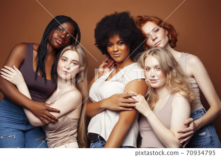 young pretty caucasian, afro, scandinavian woman posing cheerful together on brown background, lifestyle diverse nationality people concept 70934795
