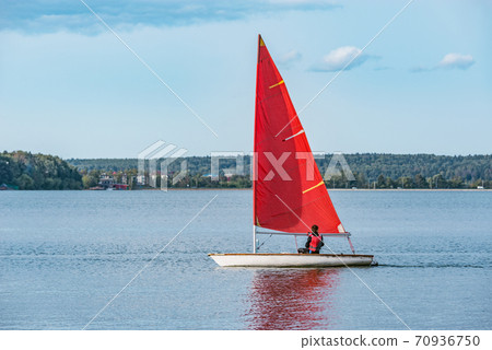 Teenager boy on the yacht. Healthy water sport. 70936750