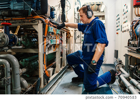 Marine engineer officer controlling vessel enginesand propulsion in engine control room ECR Marine engineer officer controlling vessel enginesand propulsion in engine control room ECR 70940583
