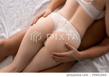 Seductive couple of lovers lying together on bed 70941844