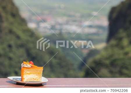 Orange cake on mountain  70942206