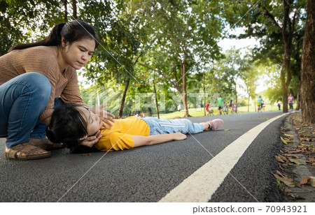 Sick daughter is fainted and fallen on floor,asian mother help, take care,exhausted teenage girl with heat stroke,high temperature,female unconscious fell to the ground suffer from sunburn very hot  70943921
