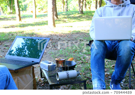 Two people doing a work at the campsite Two people doing a work at the campsite 70944489