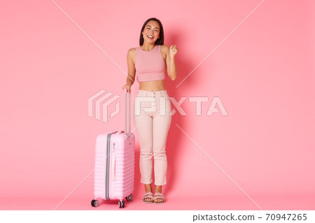 Travelling, holidays and vacation concept. Full-length of cheerful smiling asian girl finally going abroad after coronavirus pandemic, standing with suitcase and rejoicing Travelling, holidays and vacation concept. Full-length of cheerful smiling asian girl finally going abroad after coronavirus pandemic, standing with suitcase and rejoicing 70947265