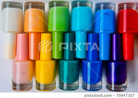 colored nail polishes on a white background 70947387