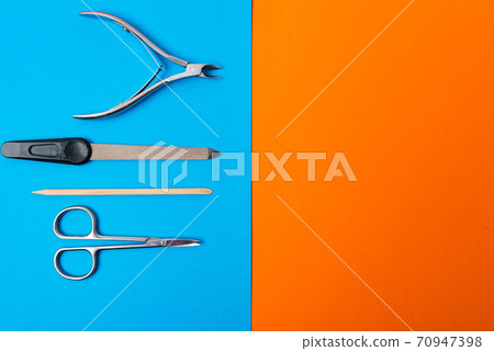 manicure set on a blue background on an orange background manicure set on a blue background on an orange background 70947398