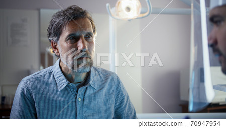 Dentist examining mature male patient Dentist examining mature male patient 70947954