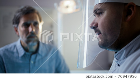 Dentist examining mature male patient Dentist examining mature male patient 70947956