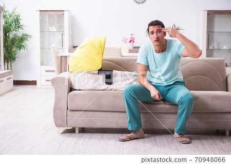 Young male parent looking after newborn at home 70948066