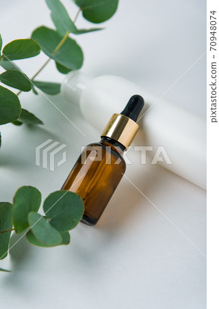 green eucalyptus leaves with tubes on a white background, beauty care 1 green eucalyptus leaves with tubes on a white background, beauty care 1 70948074