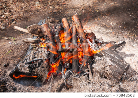 Camping bonfire under sunlight Camping bonfire under sunlight 70948508