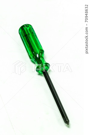 Green handle screwdriver on white background. 70948632