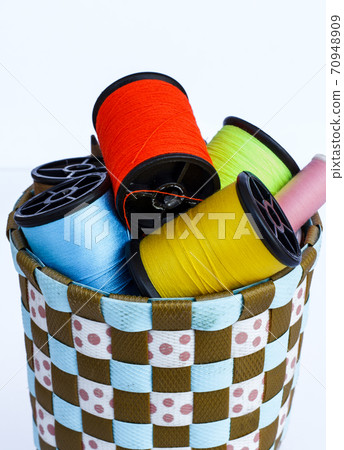 Spool of thread and needle on a white background Spool of thread and needle on a white background 70948909