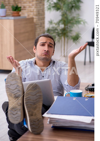 Young male bookkeeper working in the office 70949321