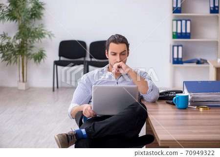 Young male bookkeeper working in the office 70949322
