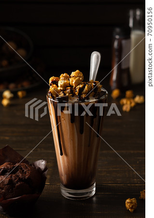 Cup with chocolate milkshake and caramel popcorn Cup with chocolate milkshake and caramel popcorn 70950156