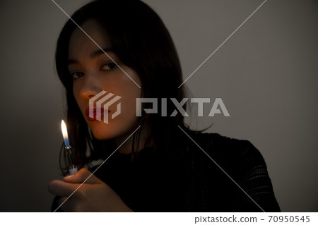Portrait of a woman with a lighter 70950545