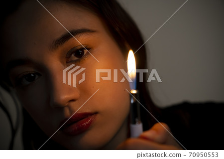Portrait of a woman with a lighter 70950553