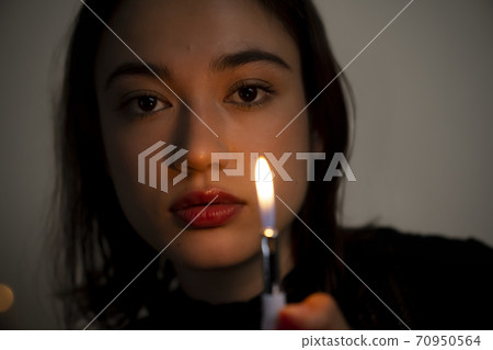 Portrait of a woman with a lighter 70950564