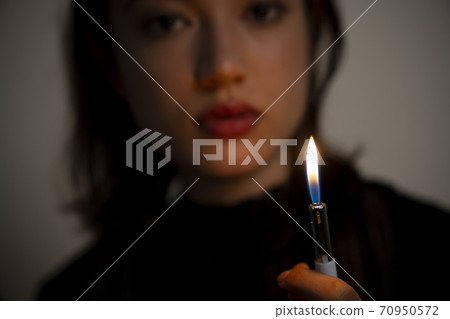 Portrait of a woman with a lighter Portrait of a woman with a lighter 70950572