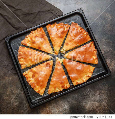 Cooked saury fish pie on a baking sheet, top view Cooked saury fish pie on a baking sheet, top view 70951233