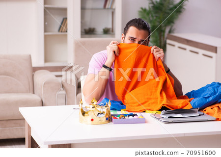 Young male tailor sewing masks at home during pandemic Young male tailor sewing masks at home during pandemic 70951600