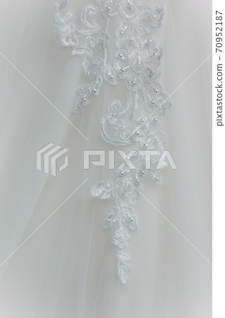 Details of the bride dress fabric and beautiful embroidery wedding concept used as a background for illustrations Details of the bride dress fabric and beautiful embroidery wedding concept used as a background for illustrations 70952187