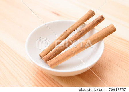 Cinnamon sticks on the plate 70952767