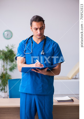 Young male doctor working in the clinic Young male doctor working in the clinic 70952813