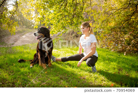 Disabled woman walking down and training outdoors in forest 70954069