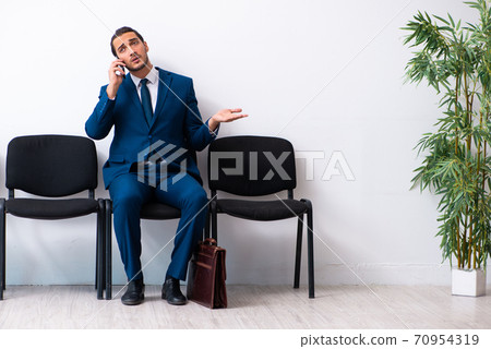 Young businessman waiting for an interview at hall 70954319